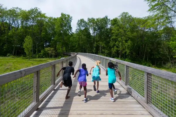 children running on a bridge in Fishers, Indiana