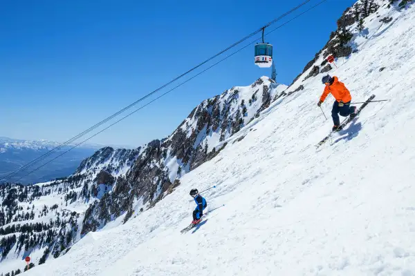 Parent and child skiing down a mountain in Layton, Utah