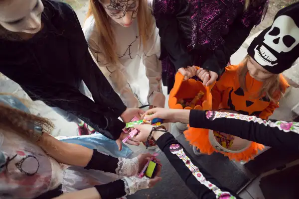 Group of children trick or treating for sweets on Halloween