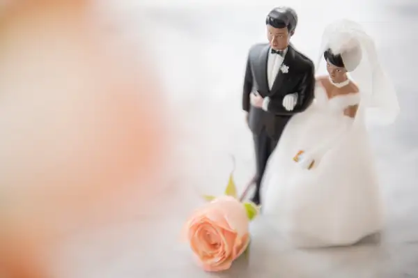 Close up of bride and groom wedding cake topper