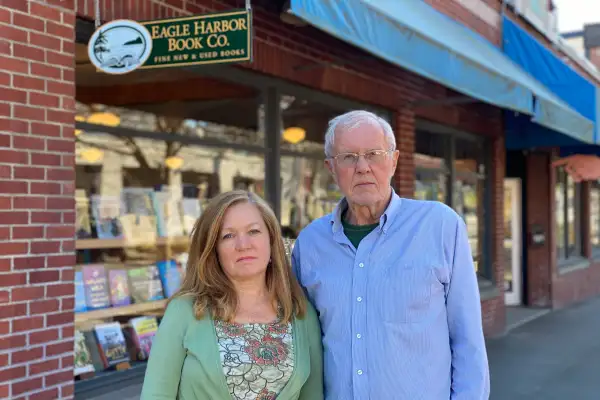 Jane Danielson and Dave Danielson in front of their bookstore, March 16, 2020.