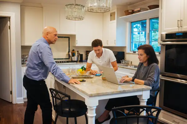 Lynn Pollack with her son and husband in their kitchen, September 2, 2020.