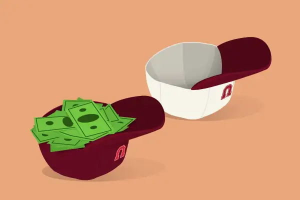 Two baseball caps upside down, one fills with cash and one without.
