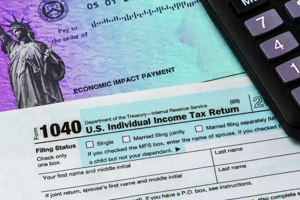Stimulus Check, 1040 Tax form and a calculator