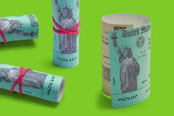 Four rolled up stimulus checks on a colored background