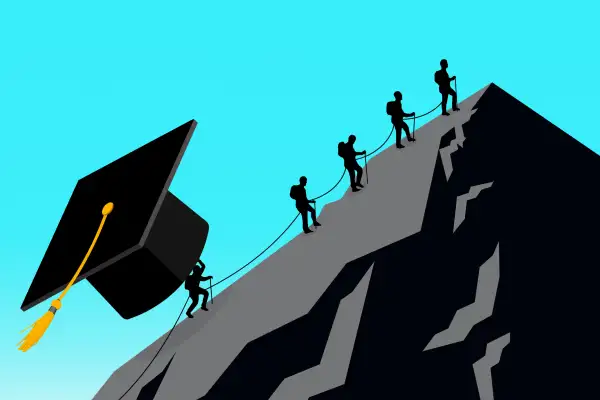 A group of people climbing a mountain, but the last person is further behind because s/he is holding a gigantic graduation cap.