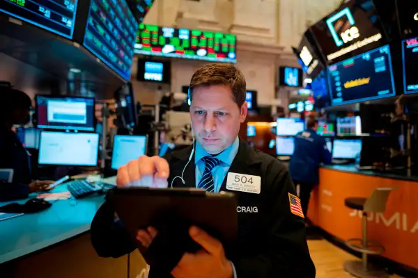 A trader works ahead of the closing bell on the floor of the New York Stock Exchange