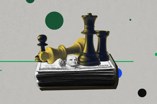 Chess piece sitting on top of a stack of money