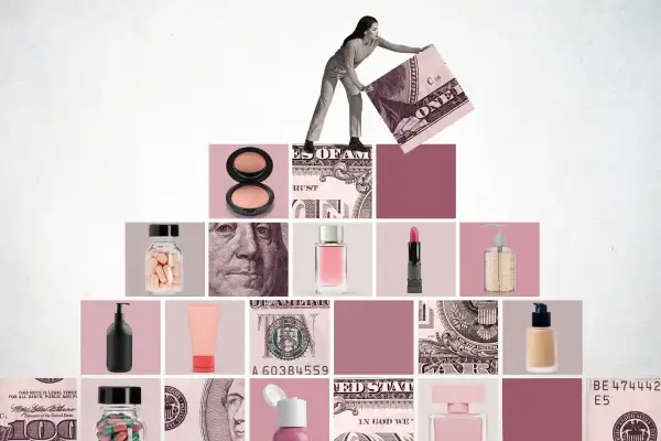 Woman lifting the final block on top of a pyramid made out of money and cosmetic products.