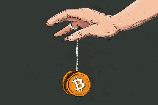 Hand Playing With A Bitcoin Shaped Yoyo