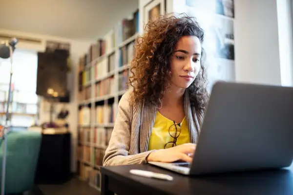 Student working at the library on her laptop