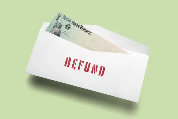 An open envelop with the word  Refund  containing a United States Treasury Check