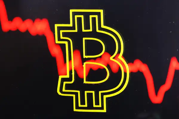 Bitcoin cryptocurrency sign with red crash line behind.
