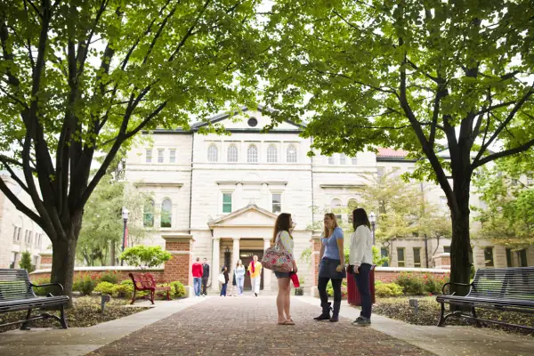 A group of students talking on the Ohio Wesleyan University campus