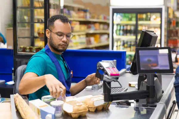 Cashier scanning groceries at checkout