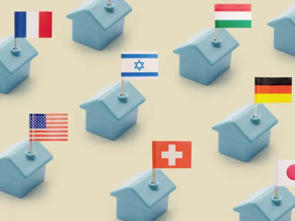 Row of miniature plastic houses with toothpick flags from Israel, France, Germany, Japan, Hungary, and the United States of America
