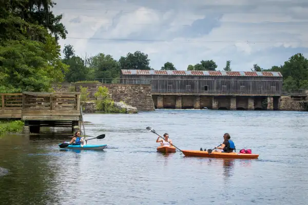 Three women kayak in Martinez Georgia