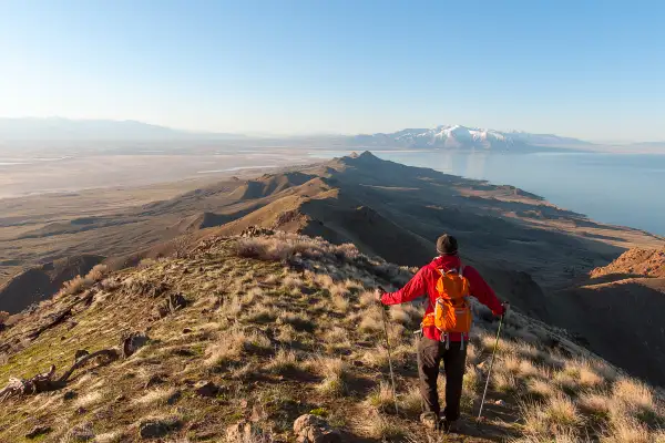 A hiker enjoys a beautiful mountain view in Syracuse Utah