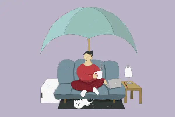Oversized Umbrella Covering A Person Sitting On A Couch With A Mini Fridge Beside Them