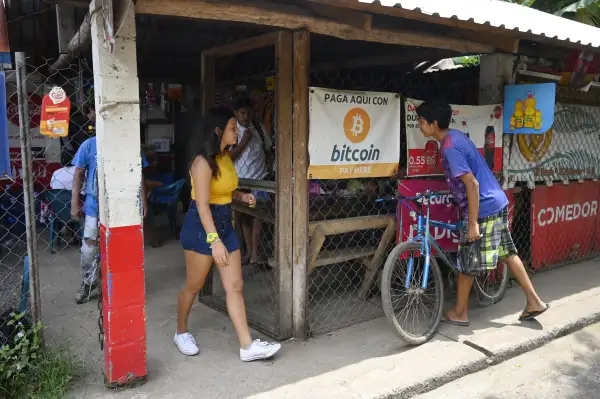 People are seen in a store where bitcoins are accepted in El Salvador