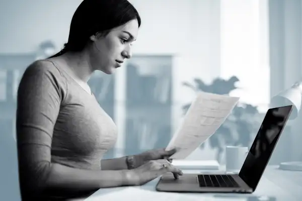 Woman filling out forms on her computer