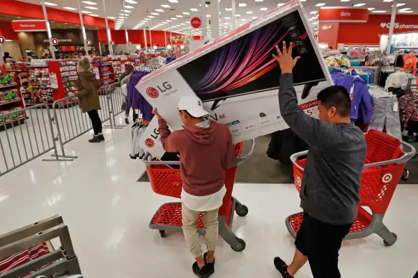 Two Men In A Store During Black Friday Placing TV Box Into A Shopping Cart