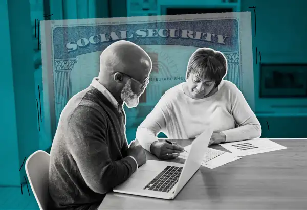 Couple Looking At Laptop And Paperwork With A Large Fading Social security card Behind Them