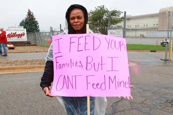 Woman Holding Kelloggs Boycott Sing That Read I Feed Your Families, But I Can't Feed Mine