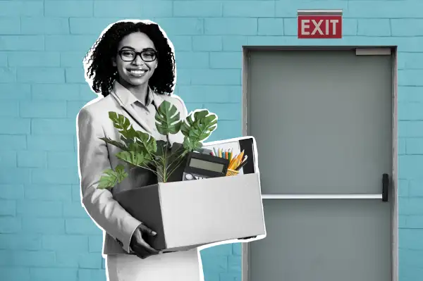 Smiling businesswoman with box of belongings headed towards the exit after resigning