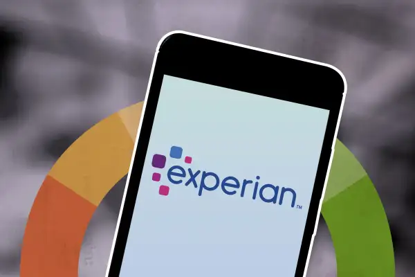 Credit Score Wheel With A Smart Phone In Front Of It Displaying An Experian Logo