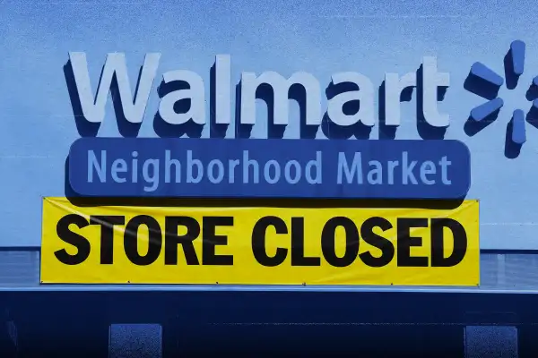 Walmart store front with a  STORE CLOSED  sign