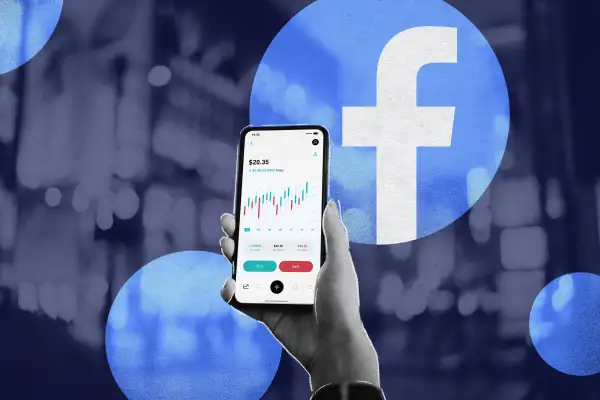 Photo illustration of a hand holding a cel phone with Facebook stock