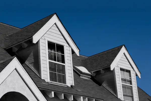 Photo illustration of a couple of triangular house rooftops