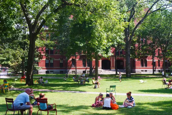 Students laying in the lawn of a college campus