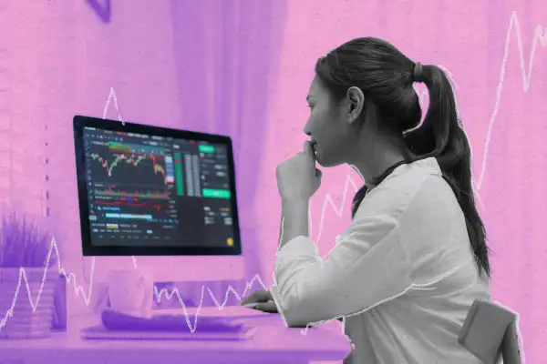 Young Asian woman sits at home on her computer watching her investments