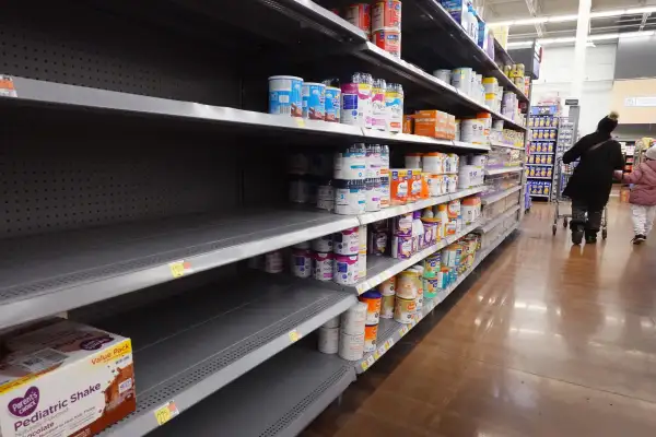 Editorial photo of an empty baby formula shelf in a supermarket store