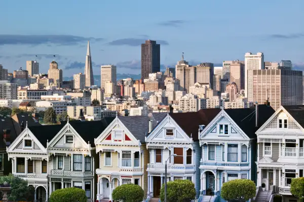 Victorian houses along Alamo Square in San Francisco, with the city landscape in the background