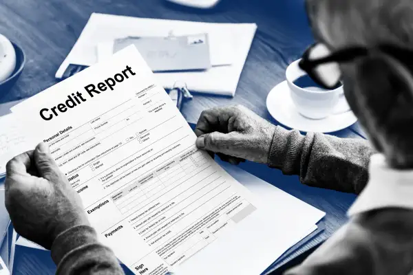 Close-up of a man holding up a credit report application