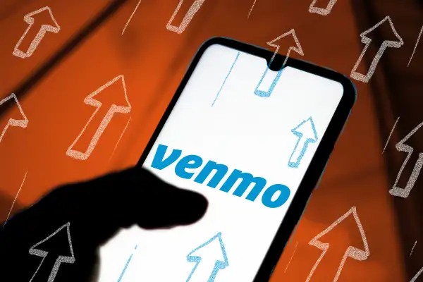 Photo illustration of a phone with the Venmo app on it and many arrows drawn on top, signifying a fee increase