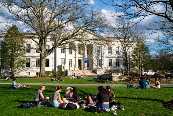 University students sit between classes on a campus lawn April 12, 2022 in Washington, DC
