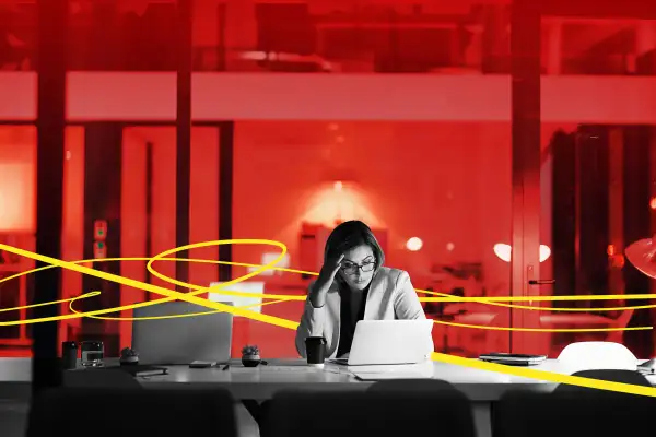 Photo Illustration of a frustrated young woman working late in an empty office