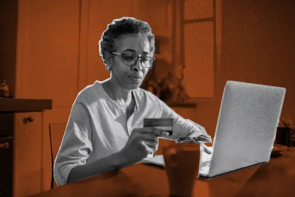 Photo of a woman using a credit card to pay online