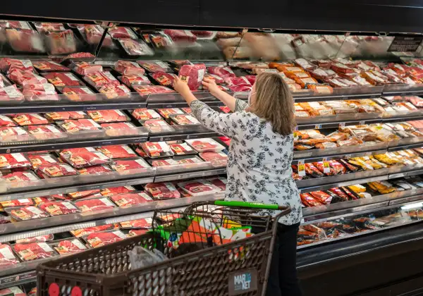 A shopper looks at a meat display at a Supermarket