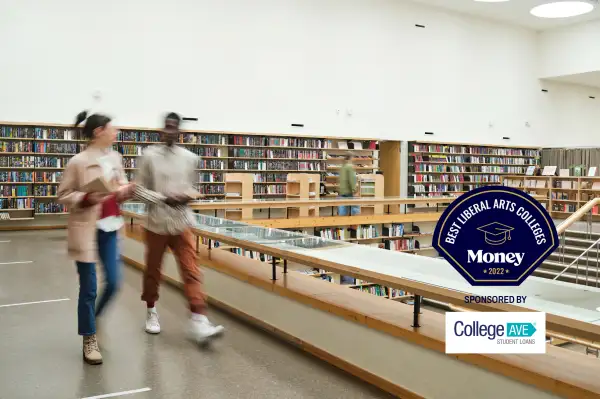 Two students walking in a college library