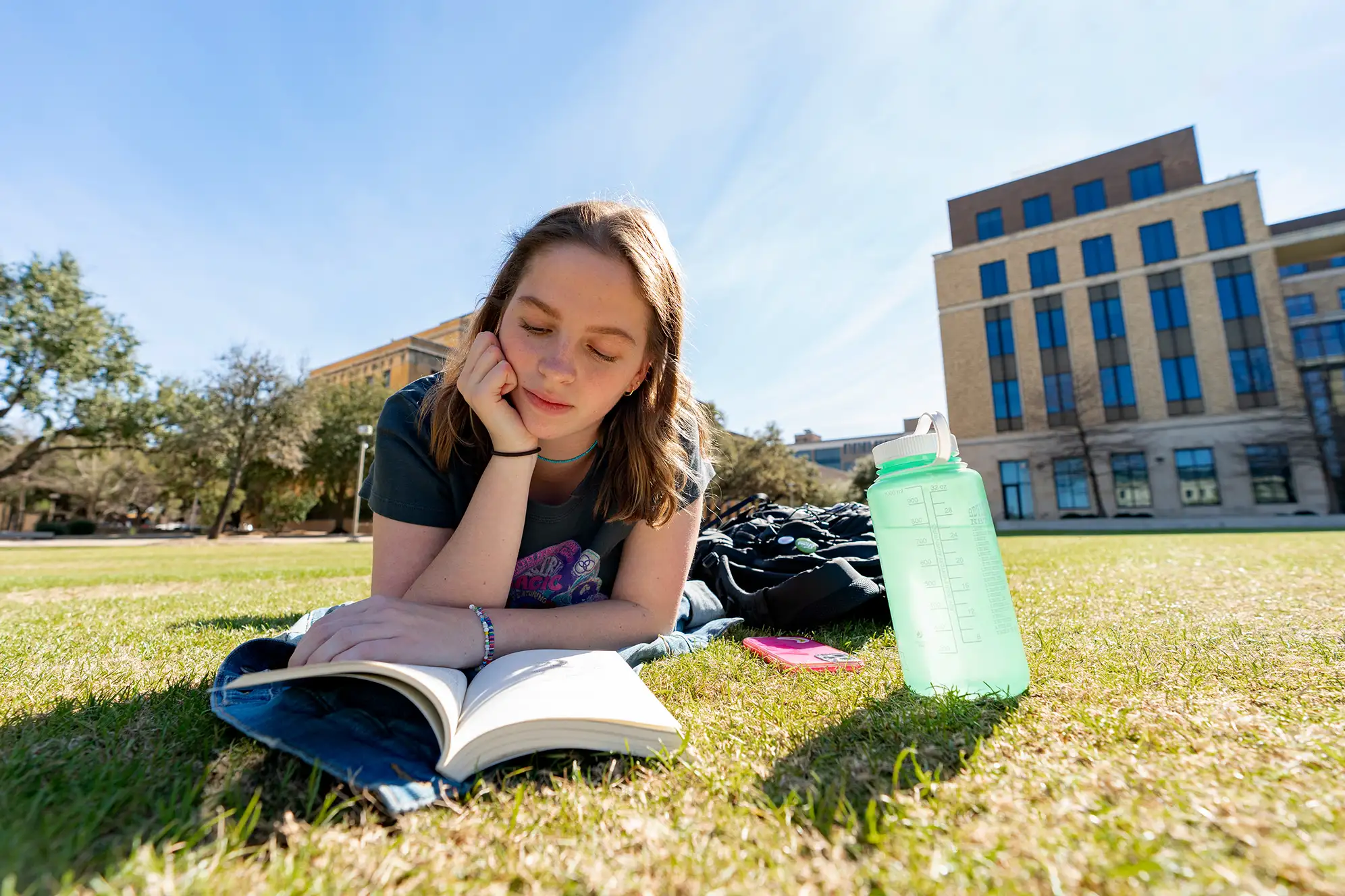 A student studies on the lawn at Texas A&amp;M University College Station
