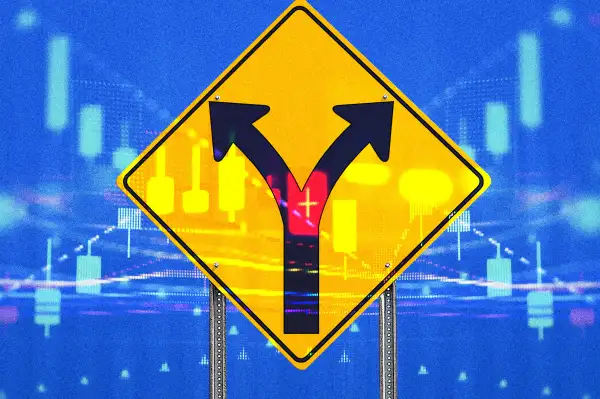 Divergent road traffic sign with and a stock market chart in the background