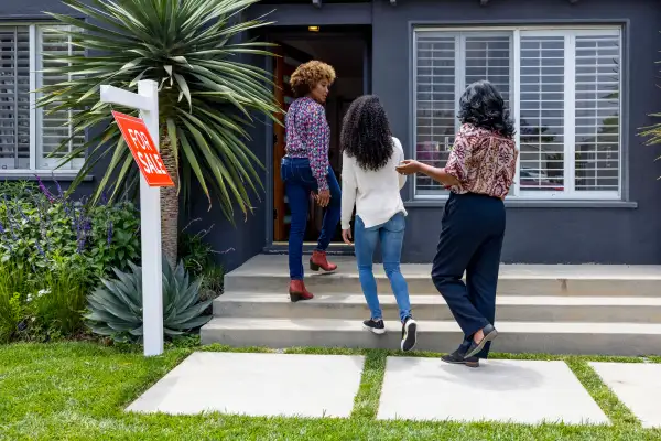 Real-estate agent showing a home for sale to a mother and daughter