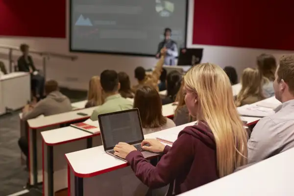 Student using their laptop during a university lecture