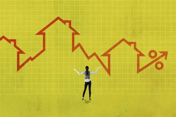Woman With Arms Raised In Front Of An Oversized Mortgage Rates Chart