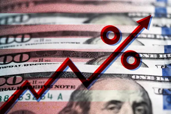 Photo illustration of some dollar bills with stripes and a percentage rate hike graph superimposed on top
